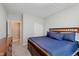 Bedroom featuring a wooden bed frame with a blue comforter and access to closet and bathroom at 9806 Olympic Blvd, Pendleton, IN 46064