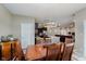 Dining room opens to kitchen and living room, featuring hardwood floors and elegant lighting at 9806 Olympic Blvd, Pendleton, IN 46064