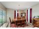 Dining room features hardwood floors, elegant lighting, and sliding glass door at 9806 Olympic Blvd, Pendleton, IN 46064