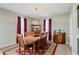 Dining room features hardwood floors, elegant lighting, and plenty of space for entertaining at 9806 Olympic Blvd, Pendleton, IN 46064