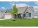 Stylish home with green lawn, covered front porch, and tasteful architectural details at 9806 Olympic Blvd, Pendleton, IN 46064