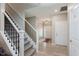 Inviting foyer with staircase, light wood floors, and views to the front door at 9806 Olympic Blvd, Pendleton, IN 46064