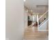 Hallway featuring beautiful light-colored floors, leading to the staircase and living area at 9806 Olympic Blvd, Pendleton, IN 46064