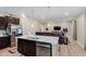 Kitchen with center island and stainless steel appliances connects to living room with hardwood floors at 9806 Olympic Blvd, Pendleton, IN 46064