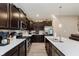 Beautiful kitchen features stainless steel appliances, white countertops, and dark wood cabinets at 9806 Olympic Blvd, Pendleton, IN 46064