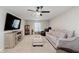 Inviting living room with comfortable seating, a ceiling fan, and a modern entertainment center at 9806 Olympic Blvd, Pendleton, IN 46064
