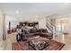 Open living space with staircase, sofa and view to the kitchen and dining areas at 9806 Olympic Blvd, Pendleton, IN 46064