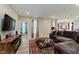 Spacious living room with large couch, hardwood floors, and natural light at 9806 Olympic Blvd, Pendleton, IN 46064