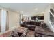 Open-concept living area featuring a comfortable sofa, rug, and view of kitchen and dining at 9806 Olympic Blvd, Pendleton, IN 46064