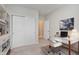 Bright office space with a glass desk, white chair, and built-in shelving at 9806 Olympic Blvd, Pendleton, IN 46064