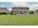 Spacious backyard with a manicured lawn and inviting patio area, ideal for outdoor living at 10107 Landis Blvd, Fishers, IN 46040