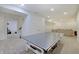 Spacious basement with carpet, perfect for recreation and entertainment, featuring a ping pong table at 10107 Landis Blvd, Fishers, IN 46040