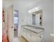 Well-lit bathroom featuring double sinks with granite countertops and views to the bedroom at 10107 Landis Blvd, Fishers, IN 46040