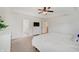Bedroom featuring tray ceilings, carpet floors, many windows, and a ceiling fan with lighting at 10107 Landis Blvd, Fishers, IN 46040