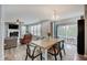 Inviting dining area with a wood table, stylish seating, and a view of the living area and outdoor patio at 10107 Landis Blvd, Fishers, IN 46040