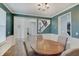 Inviting dining room with wood table, wainscoting, chandelier, and a view of the staircase at 10107 Landis Blvd, Fishers, IN 46040