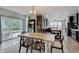 Bright dining area with a table, direct patio access, seamlessly connected to the gourmet kitchen and living space at 10107 Landis Blvd, Fishers, IN 46040