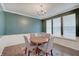 Dining room with a round table, four chairs, a chandelier, and three large windows at 10107 Landis Blvd, Fishers, IN 46040