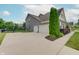 View of three-car garage, basketball hoop and a well-maintained lawn and landscaping at 10107 Landis Blvd, Fishers, IN 46040