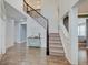 Bright, two-story foyer with hardwood floors, staircase, and wainscoting details at 10107 Landis Blvd, Fishers, IN 46040