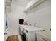 Practical laundry room equipped with a washer, dryer, and storage shelves for efficient cleaning at 10107 Landis Blvd, Fishers, IN 46040
