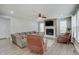 Bright living room featuring a stone fireplace, ceiling fan, and neutral-toned furniture for relaxation at 10107 Landis Blvd, Fishers, IN 46040