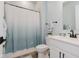 Well-lit bathroom with a shower featuring an ombre curtain, a sleek vanity, and coordinated fixtures at 10725 Crum Ct, Fishers, IN 46037