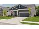 Inviting gray home featuring a two-car garage, a well-maintained lawn, and an American flag displayed at 10725 Crum Ct, Fishers, IN 46037
