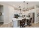 Modern kitchen with white cabinets, stainless steel appliances, an island and pendant lights at 10725 Crum Ct, Fishers, IN 46037