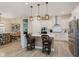 Bright kitchen with a large island, stainless steel appliances, white cabinets, and pendant lighting at 10725 Crum Ct, Fishers, IN 46037