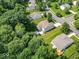 An aerial view of the home with a large, private backyard and inviting deck surrounded by mature trees at 1119 Albemarle Cir, Noblesville, IN 46062