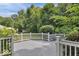 An expansive deck is surrounded by mature trees, offering privacy and tranquility at 1119 Albemarle Cir, Noblesville, IN 46062