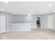 Spacious bonus room with neutral carpet, blue walls, and a pair of bright white doors at 1119 Albemarle Cir, Noblesville, IN 46062