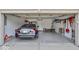 Attached garage with epoxy flooring, storage racks, and a parked car at 1119 Albemarle Cir, Noblesville, IN 46062