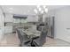 Eat-in kitchen with stainless appliances, island, and elegant chandelier at 1119 Albemarle Cir, Noblesville, IN 46062