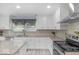 Kitchen with stainless appliances, island, and white cabinetry at 1119 Albemarle Cir, Noblesville, IN 46062