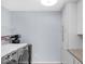 Well-lit laundry room with grey washer and dryer, white cabinets, and white shelf for storage at 1119 Albemarle Cir, Noblesville, IN 46062