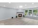 Bright living room boasts fireplace, large windows, and natural light at 1119 Albemarle Cir, Noblesville, IN 46062