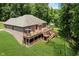 Aerial view highlights backyard multi-level deck, landscaping, brick house, and mature trees at 1125 Observatory Rd, Martinsville, IN 46151