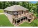 Aerial view of a brick house with decks, a well-maintained lawn, landscaping, and mature trees at 1125 Observatory Rd, Martinsville, IN 46151