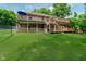 Expansive backyard featuring multi-level deck, verdant lawn, and secure fencing for outdoor enjoyment at 1125 Observatory Rd, Martinsville, IN 46151