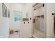 Bright bathroom with patterned tile floor, glass shower, white walls, black fixtures and a window at 1125 Observatory Rd, Martinsville, IN 46151