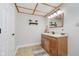 Bathroom features warm-toned vanity, decorative mirror, and grid-pattern ceiling, plus patterned rug and neutral paint at 1125 Observatory Rd, Martinsville, IN 46151