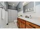 Bathroom with wood vanity, large mirror, and shower with decorative curtain at 1125 Observatory Rd, Martinsville, IN 46151