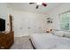 This bedroom features a ceiling fan, neutral paint and carpet and three closets for storage at 1125 Observatory Rd, Martinsville, IN 46151
