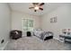 Cozy bedroom with soft carpet, ceiling fan, neutral paint, and plenty of natural light at 1125 Observatory Rd, Martinsville, IN 46151
