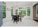 Bright breakfast nook with backyard view, featuring deck access, chandelier and white tile floors at 1125 Observatory Rd, Martinsville, IN 46151