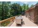 Spacious wood deck with dining set, railing, and beautiful natural backdrop of lush greenery at 1125 Observatory Rd, Martinsville, IN 46151
