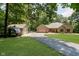A charming home features a detached garage and RV parked on the driveway, surrounded by lush greenery at 1125 Observatory Rd, Martinsville, IN 46151