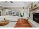 Living room with stone fireplace, seamless view into kitchen and dining area, and hardwood floors at 1125 Observatory Rd, Martinsville, IN 46151